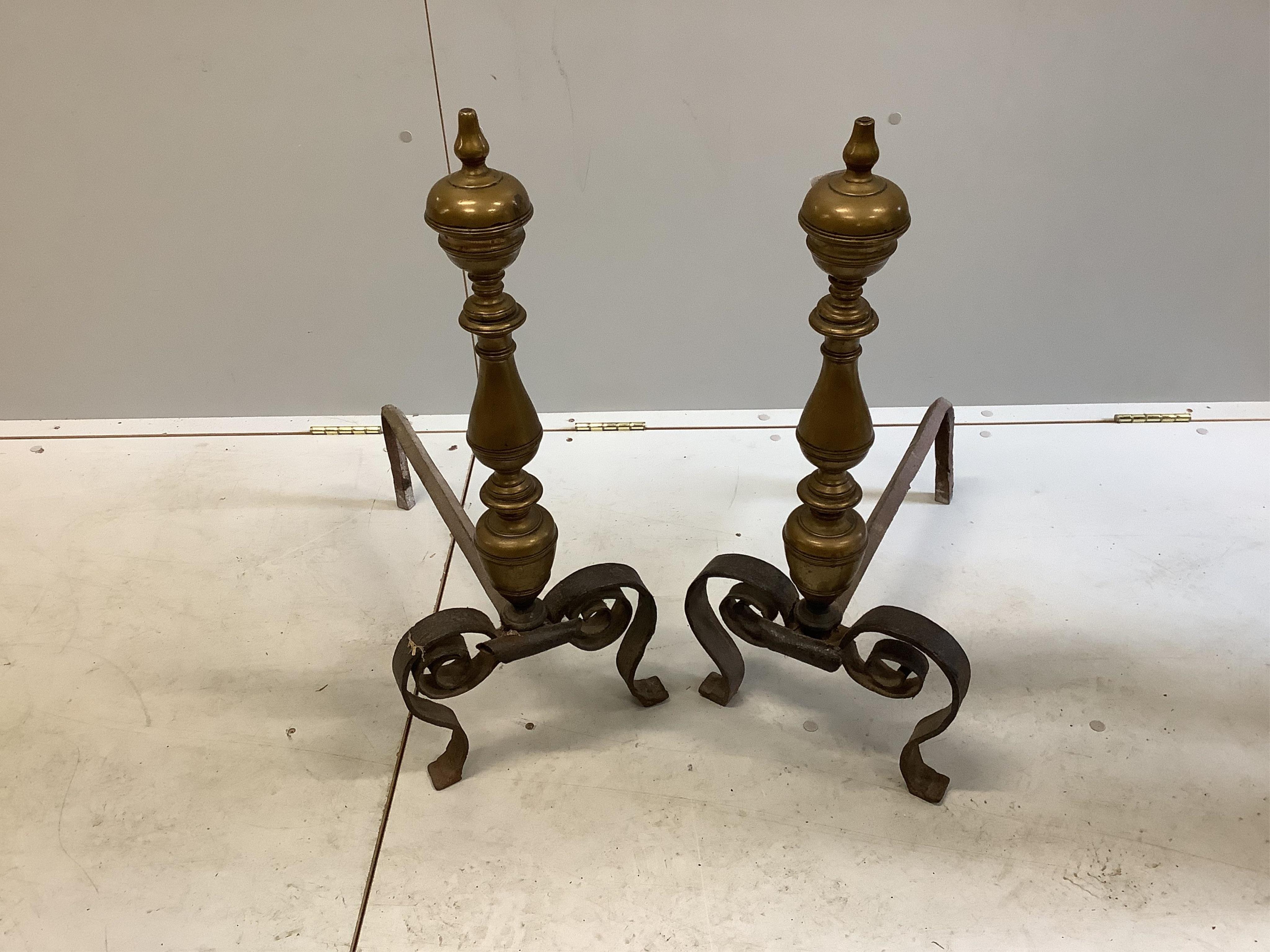 A pair of brass and wrought iron fire dogs, length 54cm, height 71cm. Condition - fair